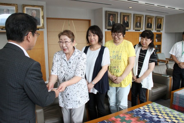 小野市長（左）に寄付金を手渡す中西委員長ら＝伊東市役所